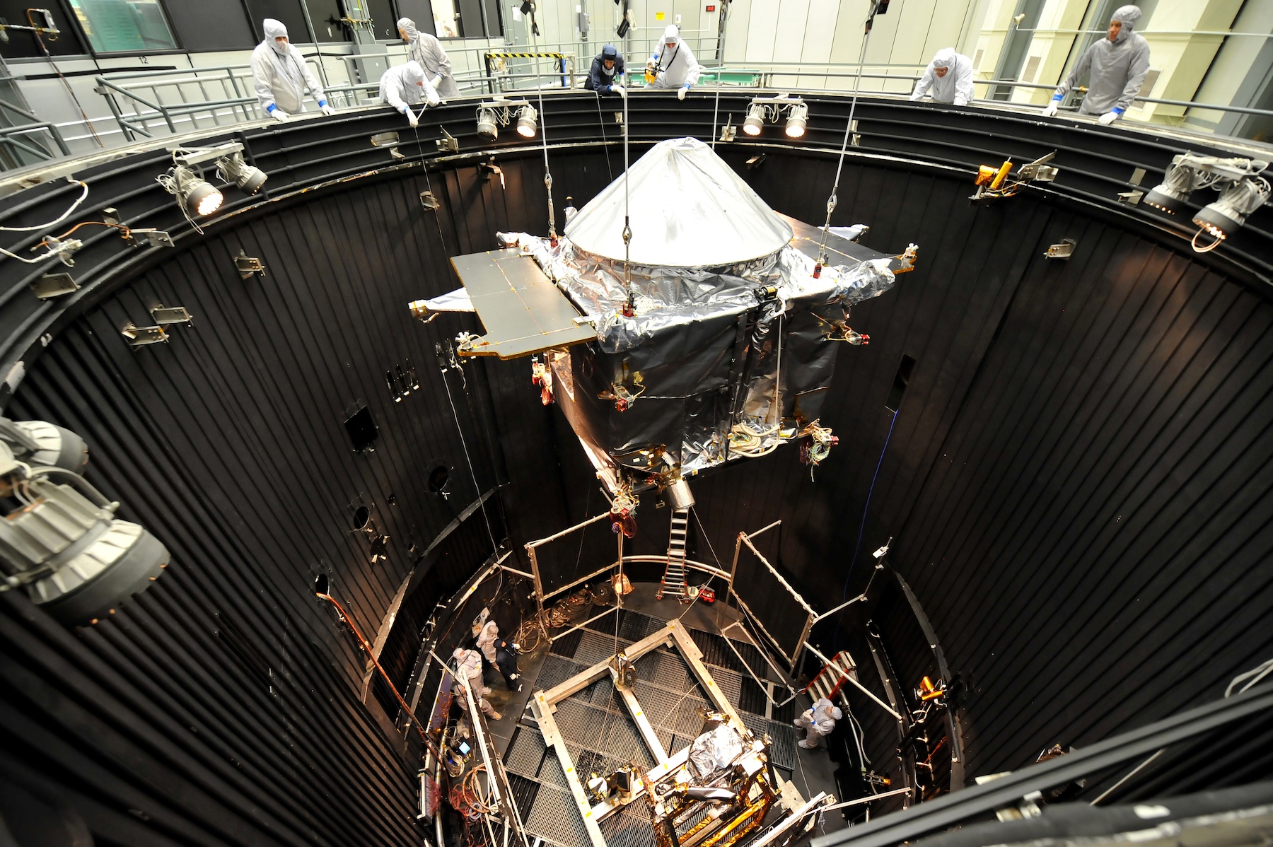 The Mars Atmosphere and Volatile Evolution (MAVEN) spacecraft is lowered into a thermal vacuum (TVAC) chamber at Lockheed Martin, near Denver, Colorado. TVAC testing ensures that the spacecraft is able to withstand the temperature extremes it will  encounter during its mission to study the upper atmosphere of Mars. (Courtesy Lockheed Martin)