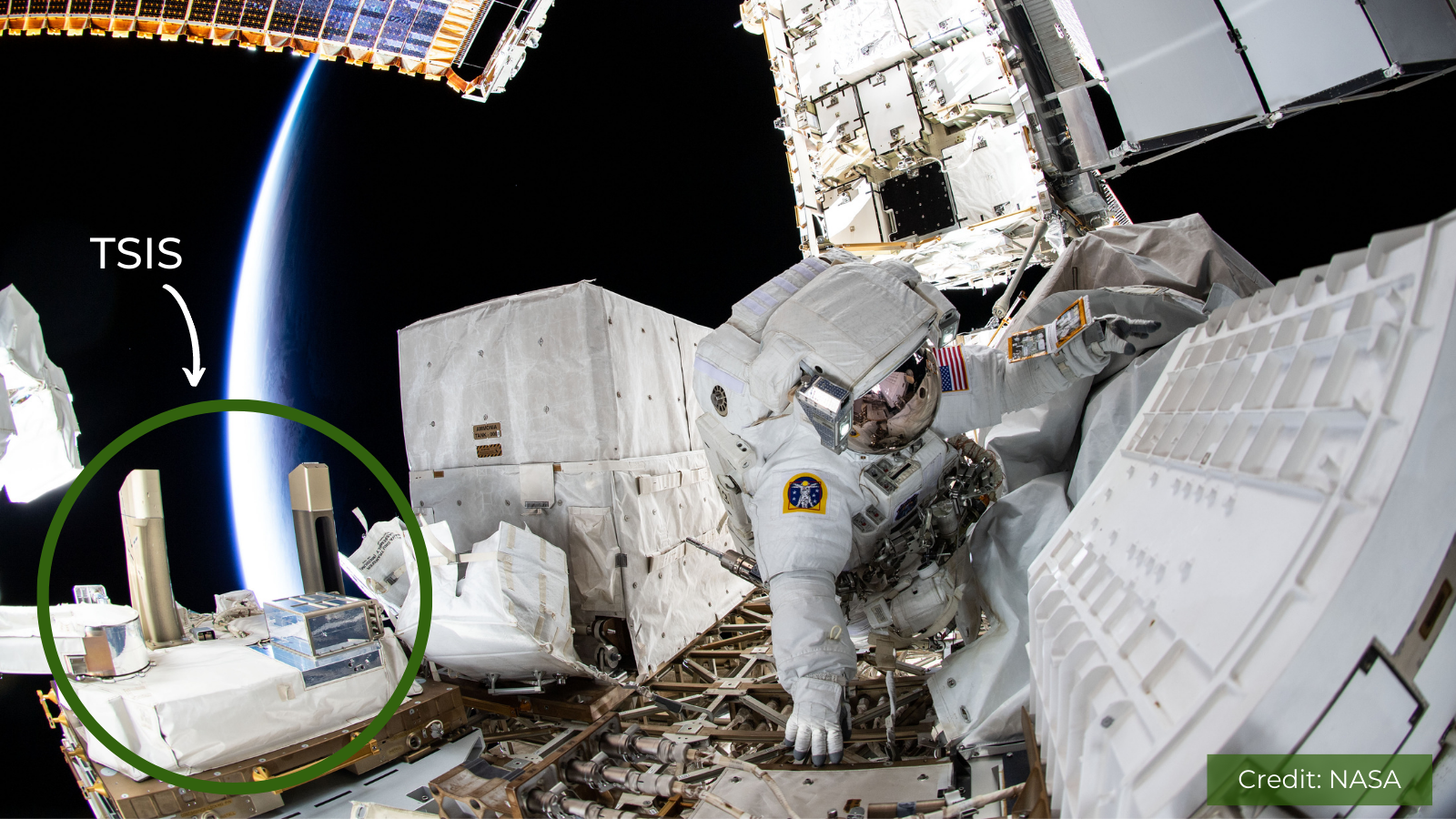 A spacewalking astronaut next to the TSIS instrument mounted on the International Space Station.