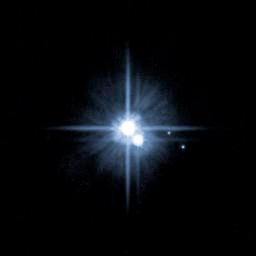 Pluto as seen from Hubble, with moons Charon, Nix, and Hydra (Courtesy NASA)