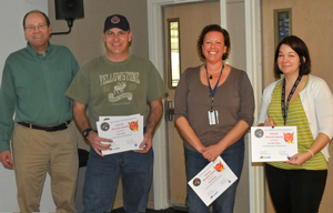Tom Woods (left) is pleased to present the Science Phoenix Award to the core SORCE Mission Operations team (right to left) Jennifer Reiter, Deb McCabe, and Sean Ryan. The LASP SORCE battery expert Emily Pilinski is missing from this photo. Photo credit: Mike Bryant, LASP.
