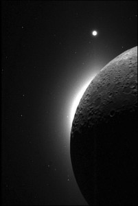 The slim, bright crescent, known as lunar horizon glow was witnessed several times during Apollo missions. This picture was taken with the Clementine spacecraft, when the sun was behind the moon. The white area on the edge of the moon is the LHG, and the bright dot at the top is the planet Venus. (Courtesy NASA)