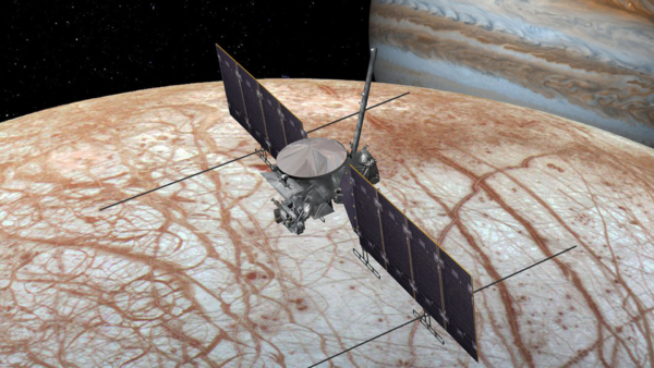 An artist's rendition of the Europa Clipper spacecraft flying above the icy moon Europa, with Jupiter visible in the background. Credit: NASA JPL