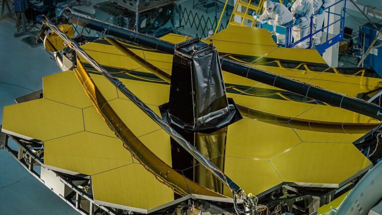 Engineers inspecting the 18 golden panels that compose the James Webb Space Telescope's primary mirror. NASA engineers used the art of origami to fold the 6.5-meter-wide mirror into the 4.5-meter-wide fairing of the rocket on which it launched. Credit: NASA/Chris Gunn