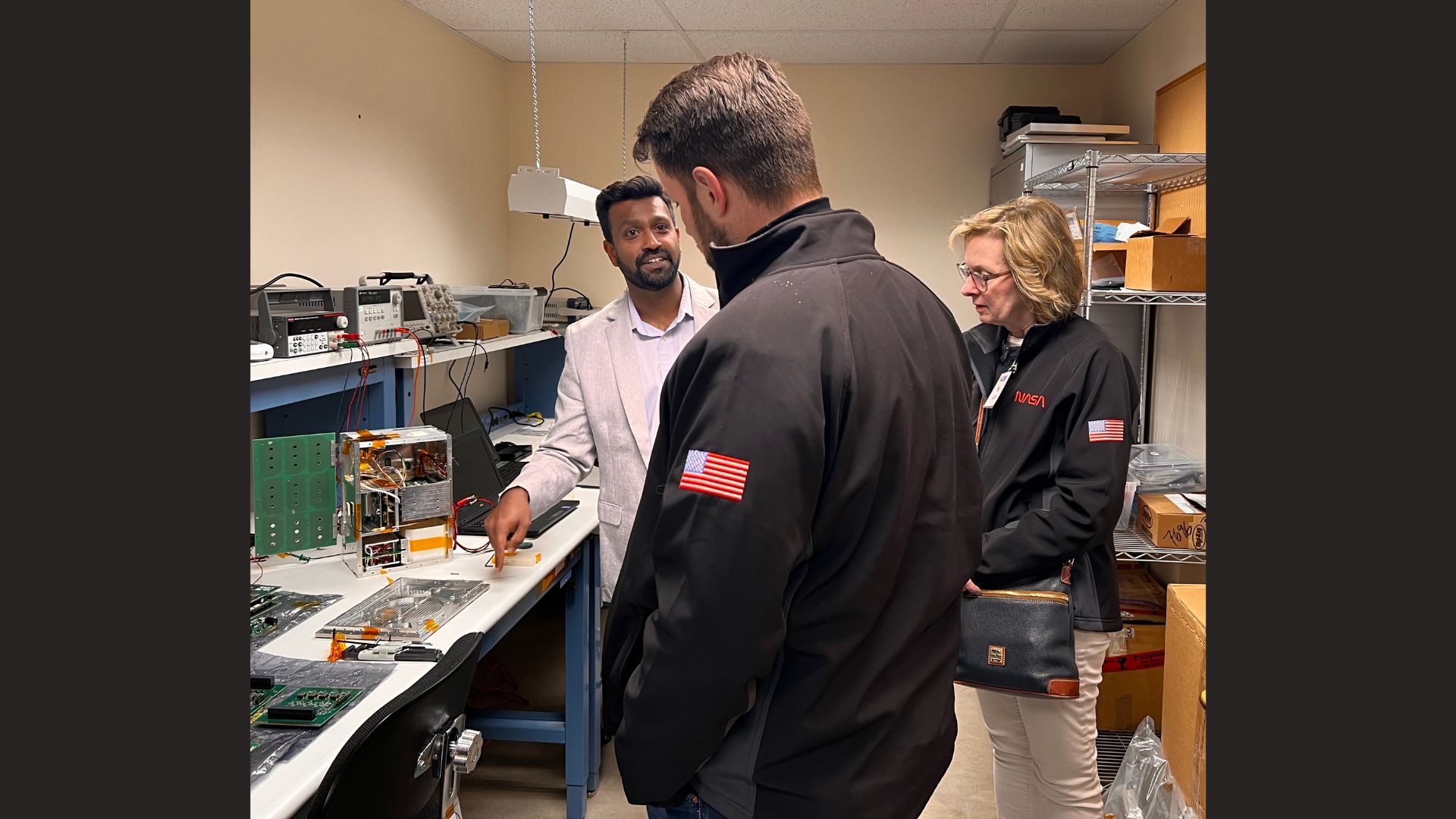 In April, NASA Heliophysics Division Director Joe Westlake (middle) and Deputy Director Peg Luce (right) toured LASP, where they saw eight different CubeSat missions currently in development and spoke with LASP CubeSat Program Lead Amal Chandran (left). Credit: LASP
