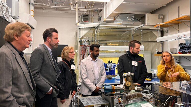 LASP researcher Briana Indahl (right) discusses the SPRITE CubeSat mission with NASA Heliophysics Division Director Joe Westlake (second from right), LASP CubeSat Program Lead Amal Chandran (middle), Heliophysics Division Deputy Director Peg Luce (third from left), NASA Space Weather Director Jamie Favors (second from left), and LASP Director Dan Baker during a tour of the Astrophysical Research Lab in April 2024. Credit: LASP