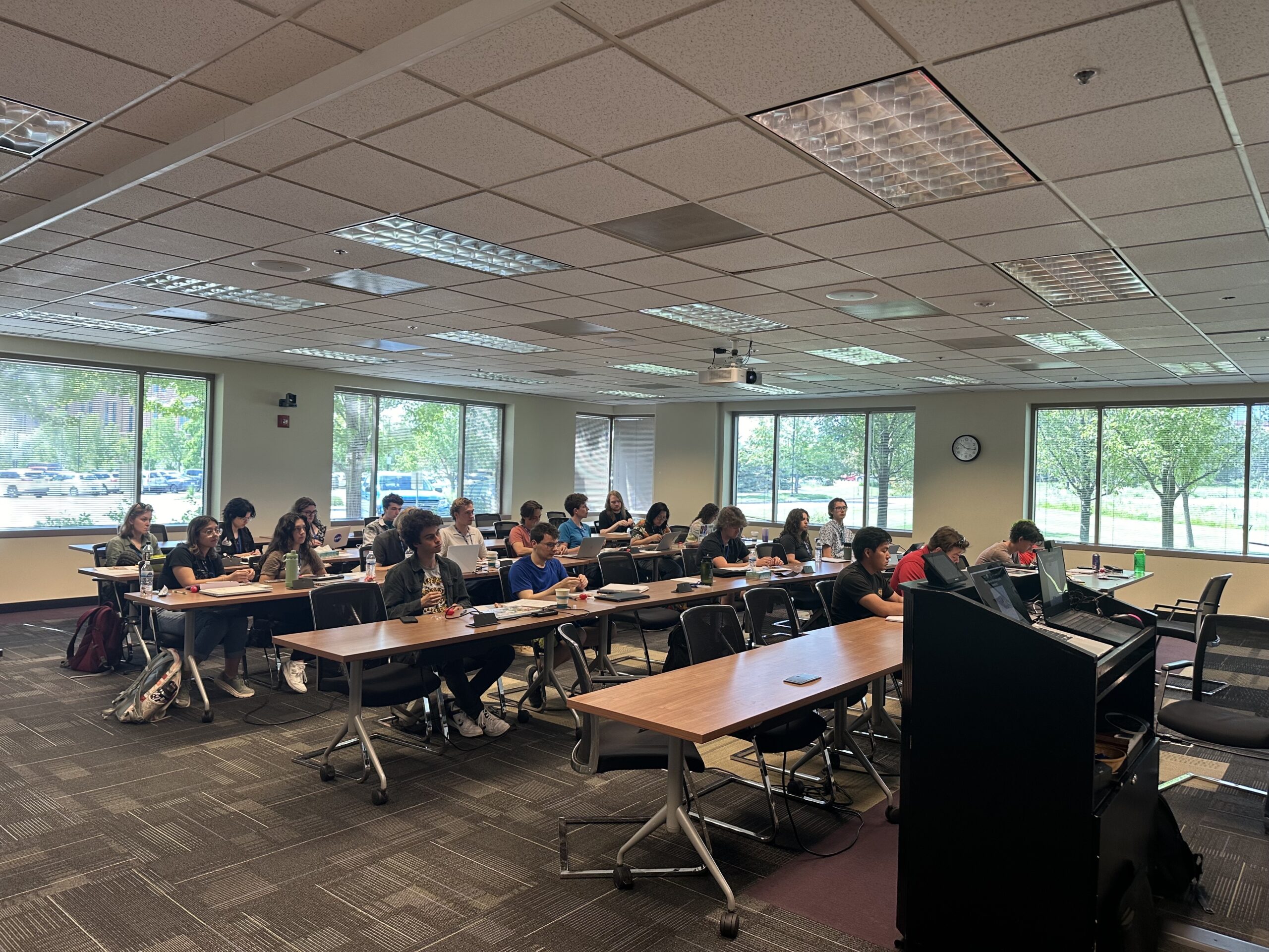 The 2024 Boulder Solar Alliance REU cohort listening to lectures during their first week of the program. Credit: LASP