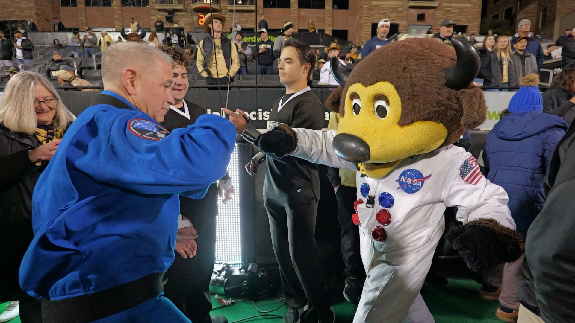 Astronaut John Grunsfeld with CU Boulder mascot Chip in his astronaut suit after Grunsfeld participated in the honorary coin-toss to kick off the Oct. 13 space-themed football game honoring LASP's 75th anniversary. Credit: CU Boulder
