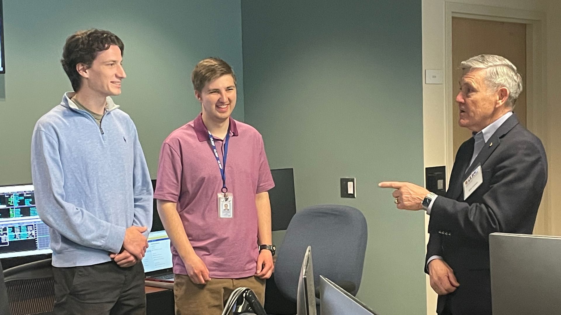 NASA Associate Administrator Bob Cabana (right) meets with undergraduate flight controllers Alex Pichler (left) and Alex Fix (center) in the LASP Mission Operations Center.